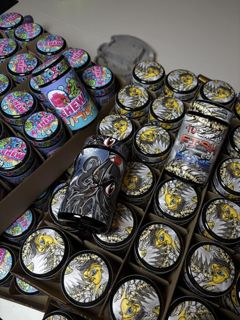 The Tenco cannabis jars at Imperial Club LA — ZChew, Black Squid, and Fishbone strains in display boxes
